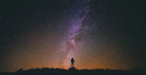 silhouette of person against the milky way star galaxy