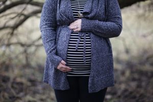 pregnant woman holding belly