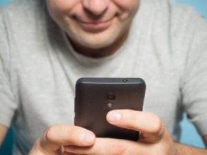 man staring at his phone