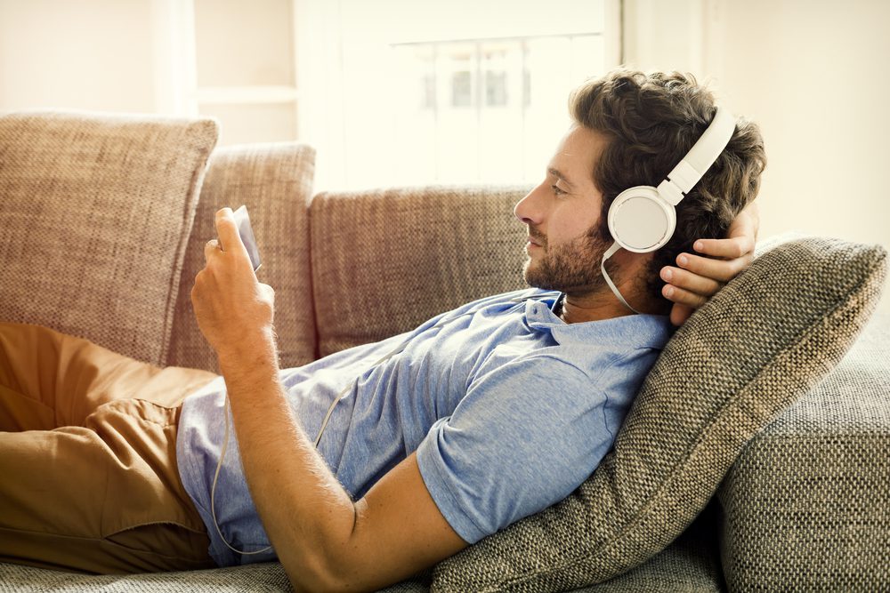 man relaxing listening to headphones