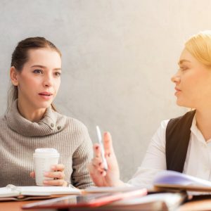 two women talking - choosing a sponsor