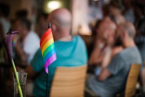 community meeting in LGBT center with small rainbow pride flag - LGBT community