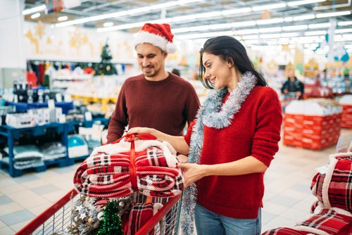 attractive couple holiday shopping in store - holiday gift ideas
