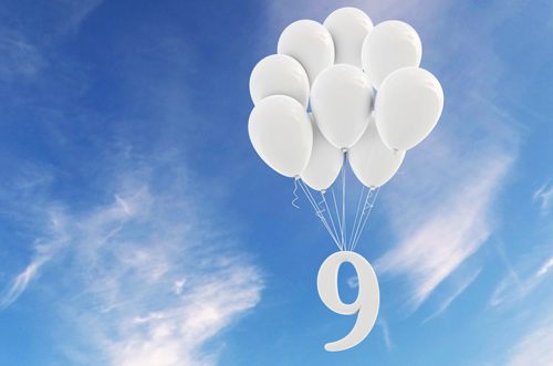 white number nine attached to white balloons, floating up into the blue sky - manage stress