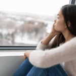 A woman looking out of a window.