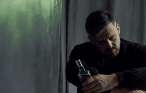 A man holding a bottle of alcohol.